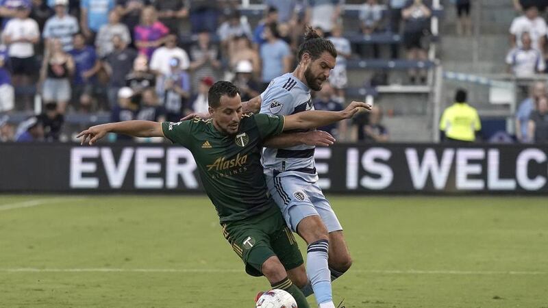 Sporting Kansas City midfielder Graham Zusi, right, and Portland Timbers midfielder Sebastián...