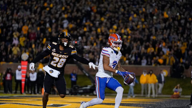 Florida wide receiver Eugene Wilson III scores past Missouri defensive back Joseph Charleston...
