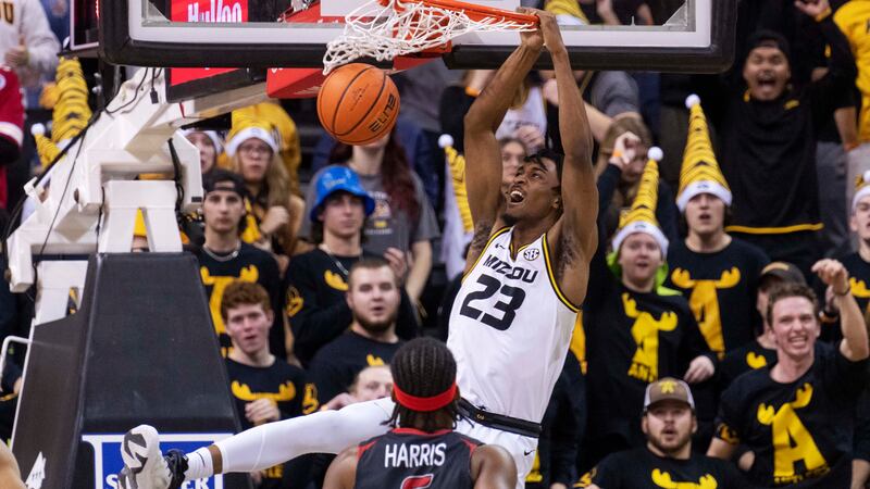 Missouri's Aidan Shaw, top, dunks the ball over Southeast Missouri State's Chris Harris during...