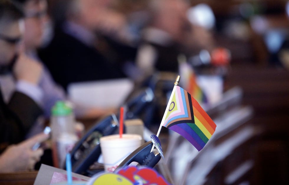 FILE - A small flag celebrating LGBTQ rights decorates a desk on the Democratic side of the...