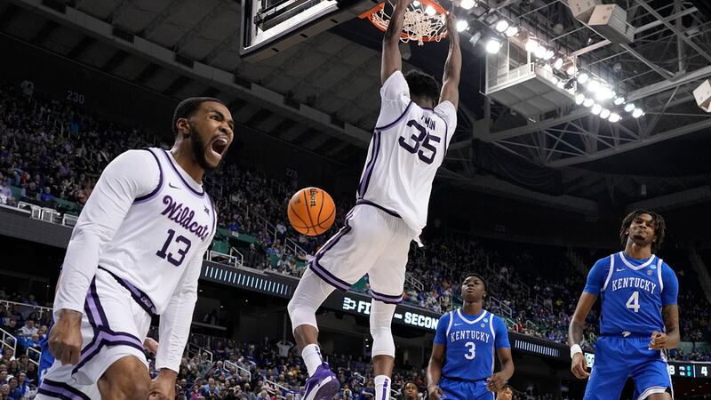 Kansas State guard Desi Sills celebrates a dunk by forward Nae'Qwan Tomlin against Kentucky...