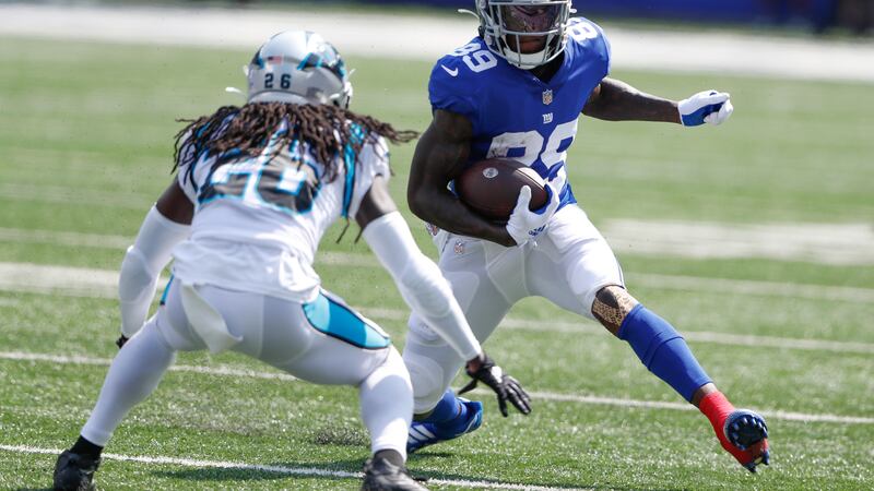 FILE - New York Giants' Kadarius Toney, right, runs with the ball during the first half an NFL...