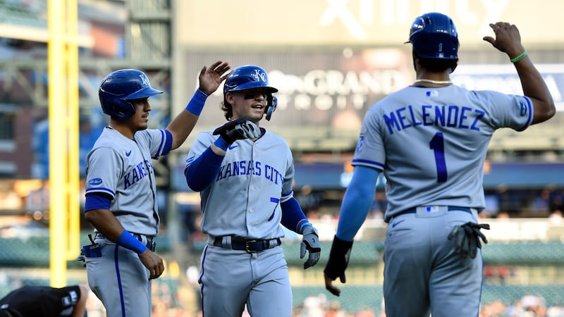 Kansas City Royals' Bobby Witt Jr., middle, is congratulated after hitting a three-run home...
