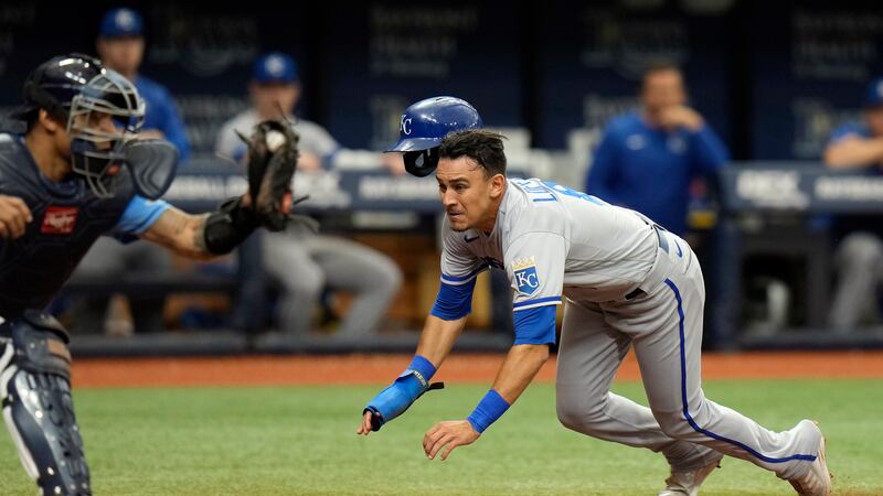 FILE: Kansas City Royals' Nicky Lopez begins to slide past Tampa Bay Rays catcher Christian...