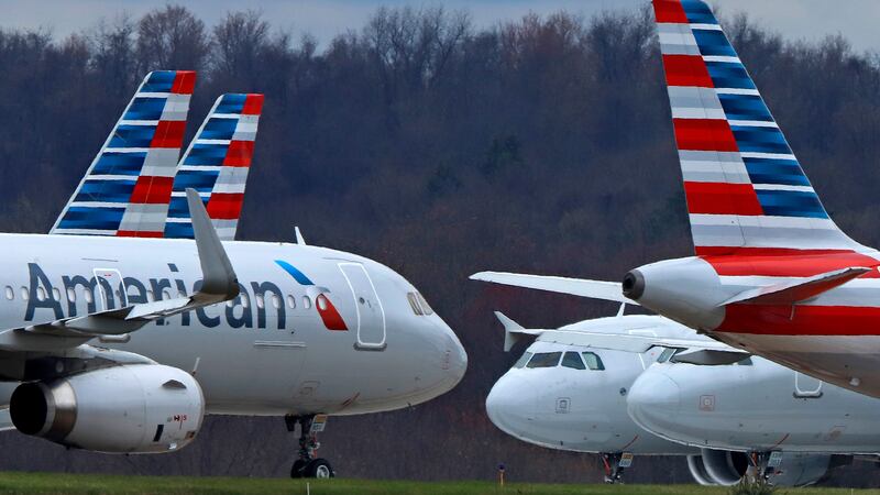 FILE - American Airlines planes sit stored at Pittsburgh International Airport on March 31,...