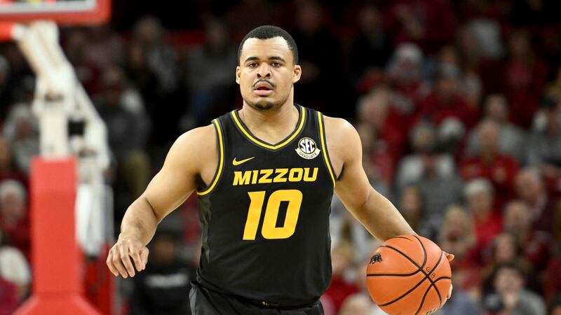 Missouri guard Nick Honor (10) runs a play against Arkansas during an NCAA college basketball...
