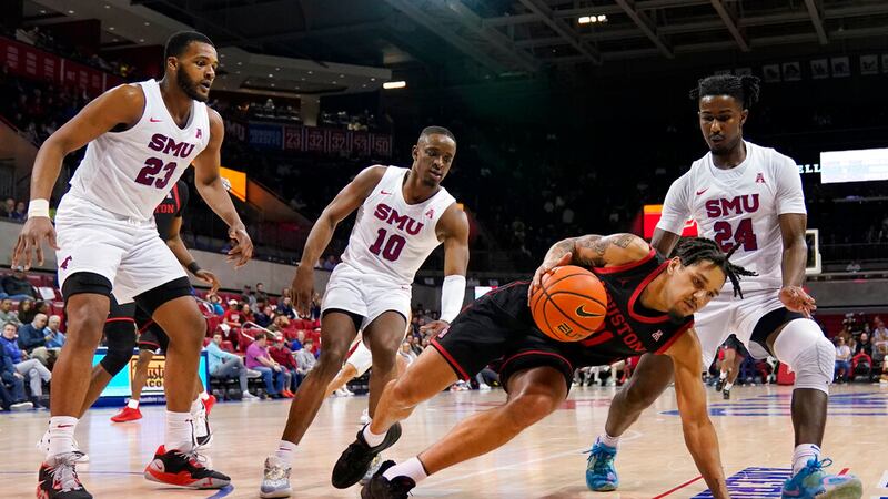 Houston guard Emanuel Sharp (21) has his fingers stepped on as he works against SMU's Efe...