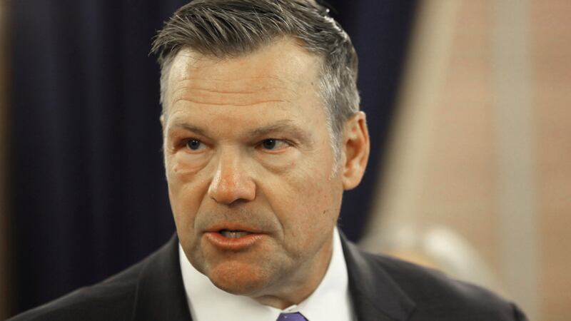 Kansas Attorney General Kris Kobach answers questions during a news conference about a new...