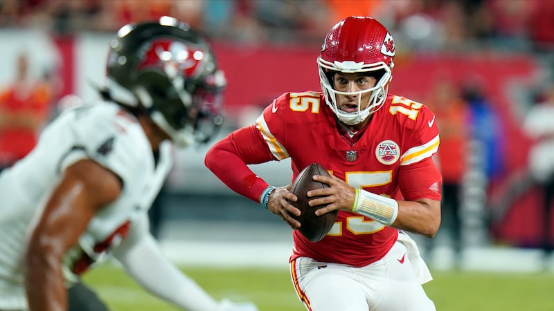 Kansas City Chiefs quarterback Patrick Mahomes (15) scrambles during the first half of an NFL...