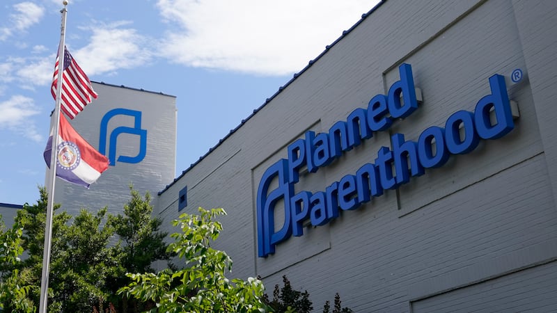 FILE - Missouri and American flags fly outside Planned Parenthood in St. Louis, June 24, 2022....