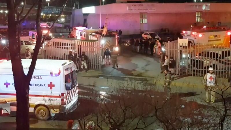 Image taken from a video showing ambulances and rescue teams staffers outside an immigration...