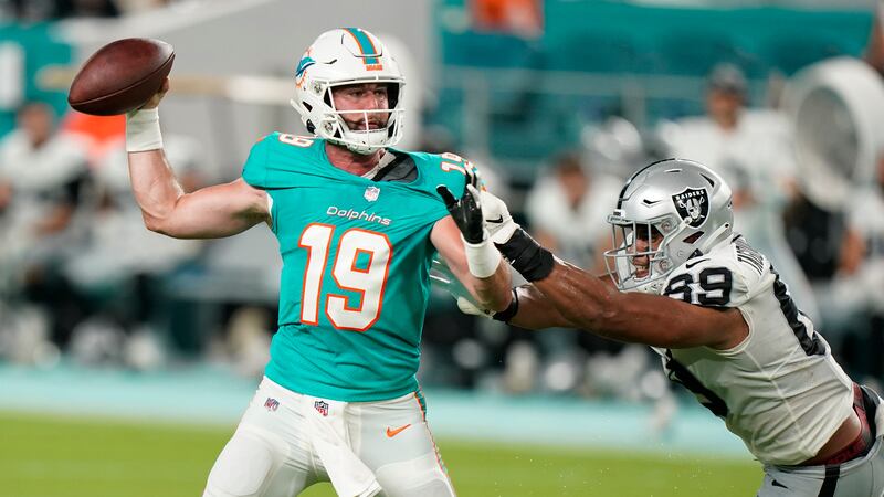 Las Vegas Raiders defensive end Myron Tagovailoa-Amosa (69) grabs Miami Dolphins quarterback...
