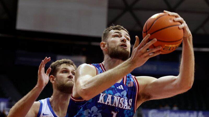 Kansas center Hunter Dickinson (1) goes for the net over Chaminade forward Wyatt Lowell (25)...