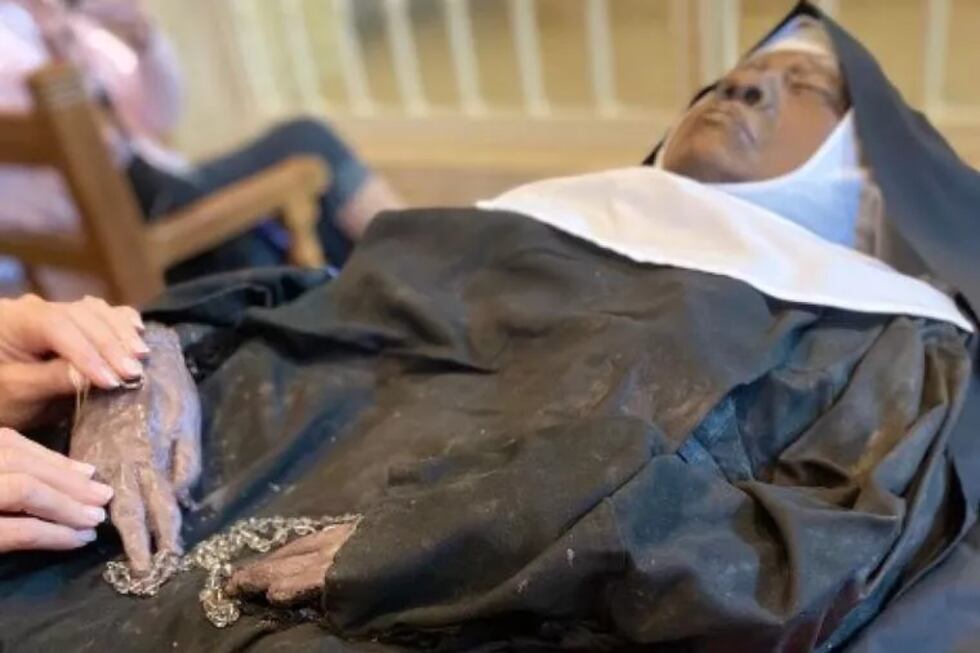 A pilgrim venerates the incorrupt body of Sister Wilhelmina Lancaster, OSB, on May 20, 2023....