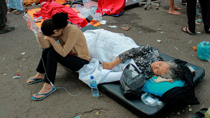 Earthquake survivors are treated outside of a hospital in Cianjur, West Java, Indonesia,...