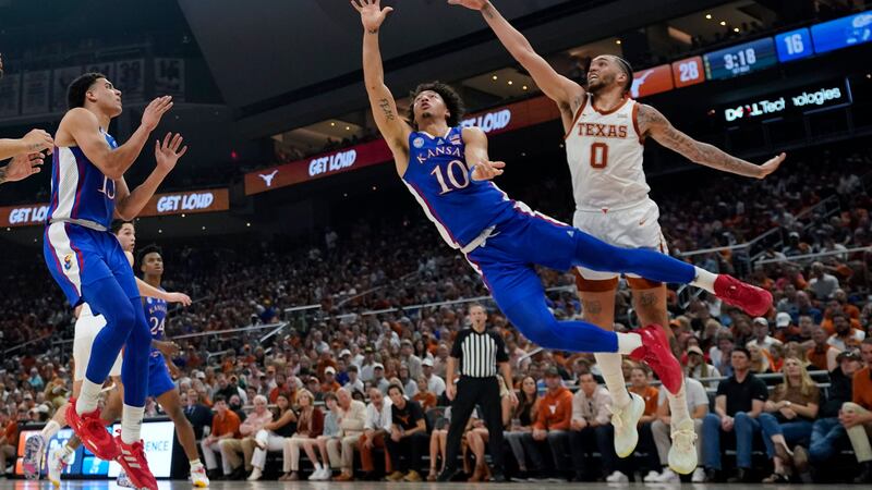 FILE - Kansas forward Jalen Wilson (10) shoots past Texas forward Timmy Allen (0) during the...